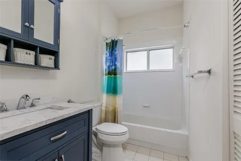 a bathroom with a sink toilet and mirror