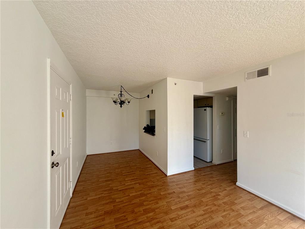 a view of a hallway with wooden floor and closet