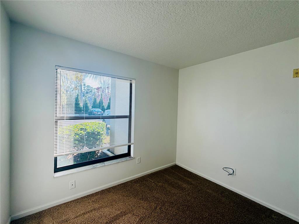 1114 South Pine Ridge Circle, Unit 14 Sanford, FL 32773 - Photo 9 of 10 an empty room with windows