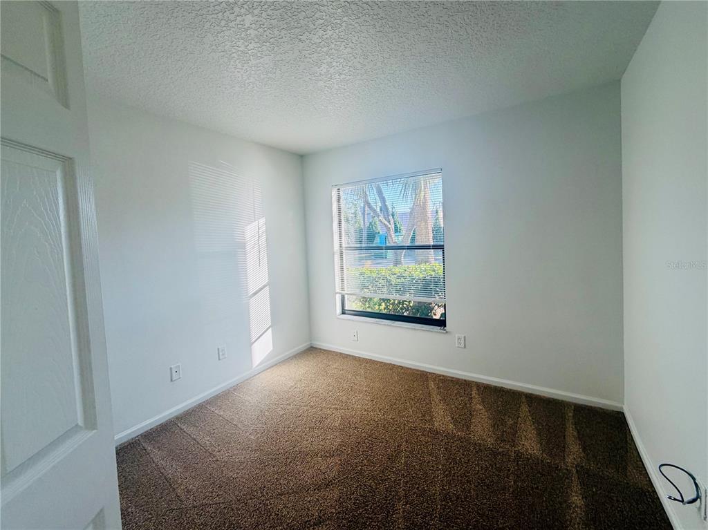 1114 South Pine Ridge Circle, Unit 14 Sanford, FL 32773 - Photo 10 of 10 a view of an empty room and window