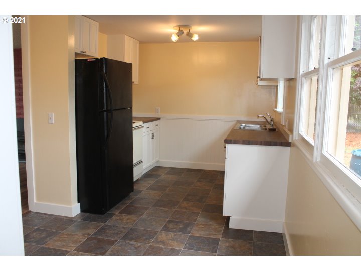 1254 Olympic Street Springfield, OR 97477 - Photo 3 of 30 a kitchen with a refrigerator and a stove