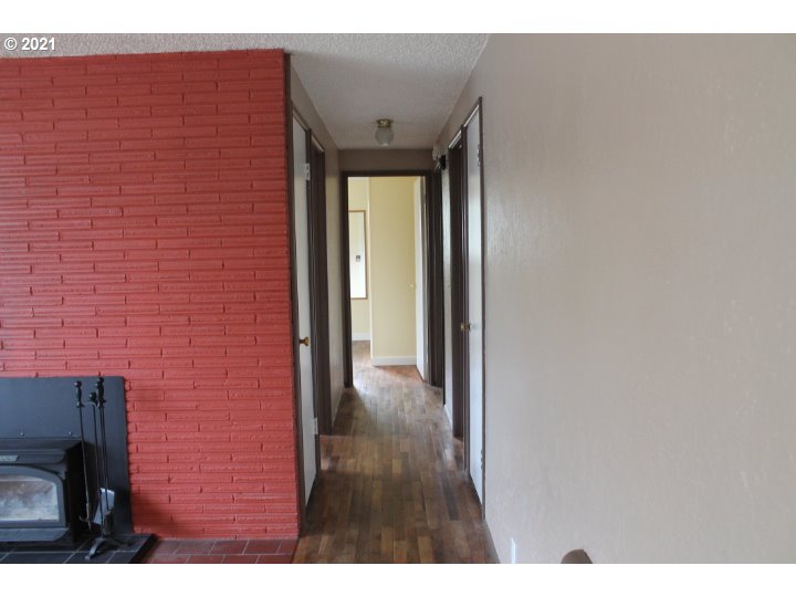 1254 Olympic Street Springfield, OR 97477 - Photo 4 of 30 a view of a hallway with wooden floor