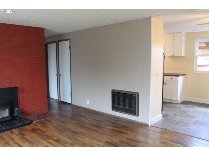 1254 Olympic Street Springfield, OR 97477 - Photo 7 of 30 a view interior of a house with wooden floor and a fireplace