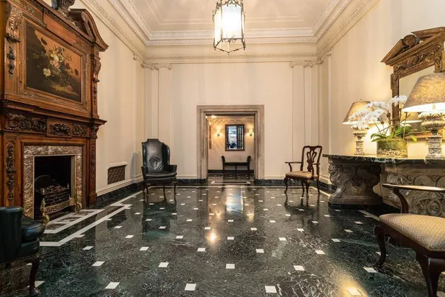 a living room with furniture a fireplace and a table