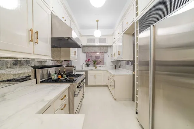 a kitchen with a sink stainless steel appliances and cabinets