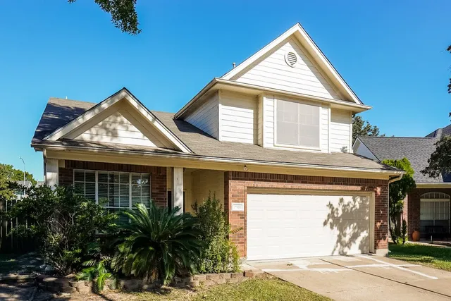 a view of a house with a yard and plants
