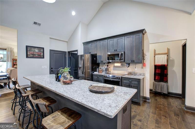 127 Alex Calhoun, GA 30701 - Photo 12 of 53 a kitchen with refrigerator cabinets and wooden floor