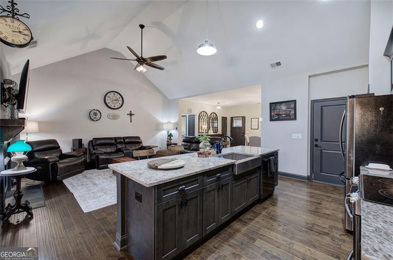 127 Alex Calhoun, GA 30701 - Photo 13 of 53 a kitchen with a counter space a sink appliances and wooden floor