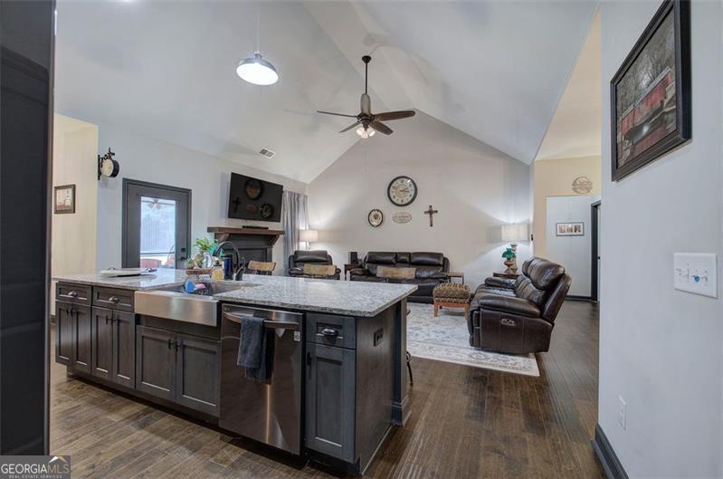 127 Alex Calhoun, GA 30701 - Photo 17 of 53 a kitchen with a stove a sink dishwasher and a dining table with wooden floor
