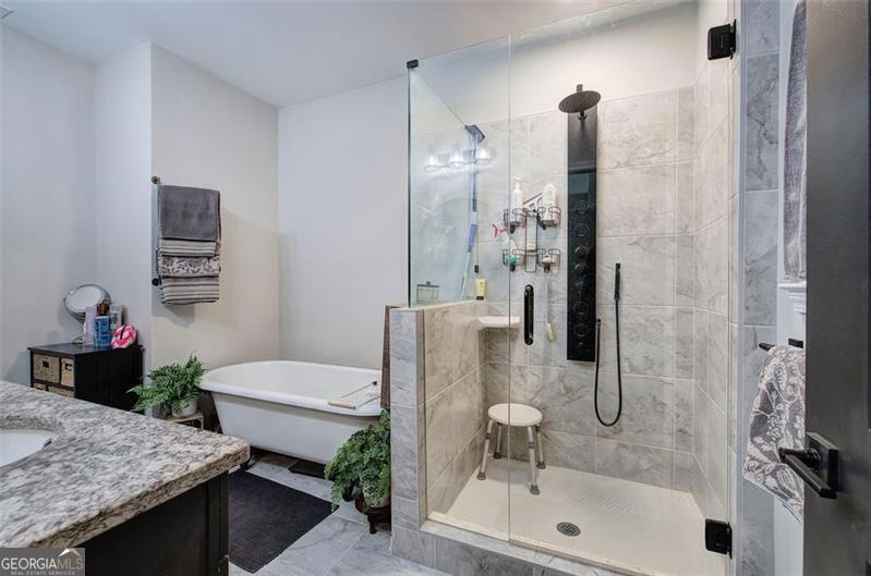 127 Alex Calhoun, GA 30701 - Photo 23 of 53 a bathroom with a granite countertop sink a toilet and shower