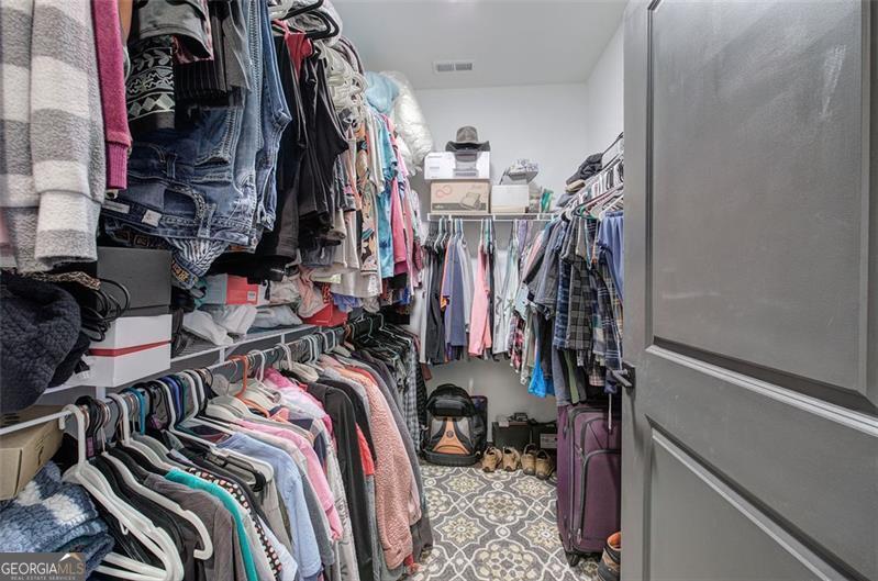 127 Alex Calhoun, GA 30701 - Photo 26 of 53 a view of walk in closet with clothes