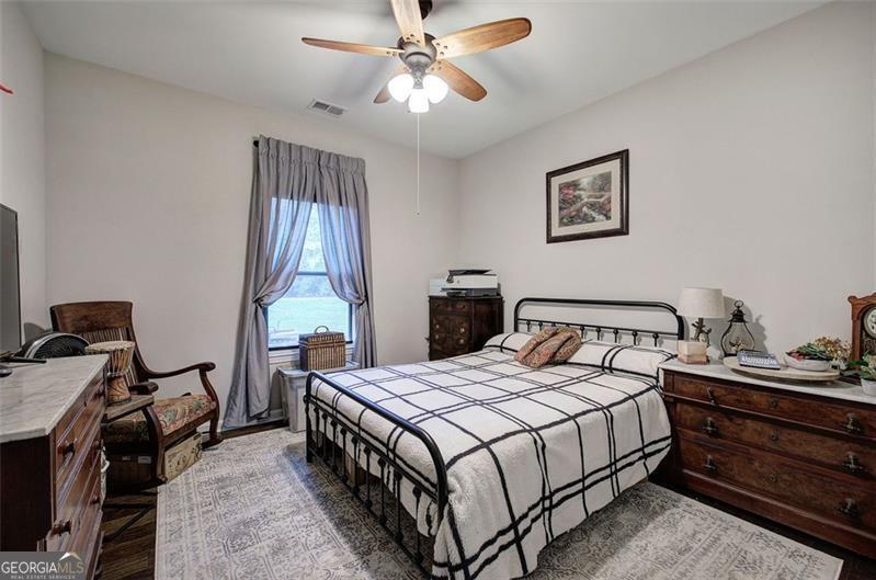 127 Alex Calhoun, GA 30701 - Photo 29 of 53 a bedroom with a bed and a chandelier