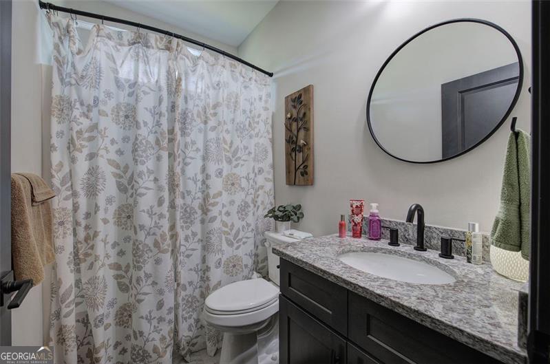127 Alex Calhoun, GA 30701 - Photo 31 of 53 a bathroom with a granite countertop sink and a mirror