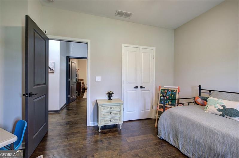 127 Alex Calhoun, GA 30701 - Photo 33 of 53 a bedroom with a bed and wooden floor