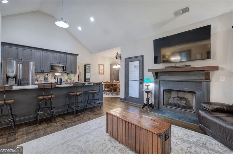 127 Alex Calhoun, GA 30701 - Photo 8 of 53 a living room with furniture a flat screen tv and a fireplace