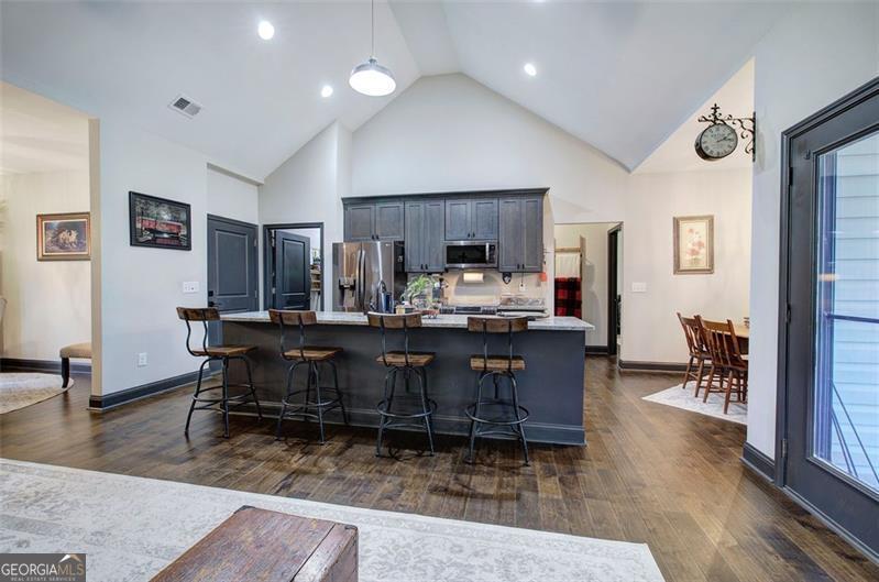 127 Alex Calhoun, GA 30701 - Photo 9 of 53 a living room with kitchen furniture and a wooden floor