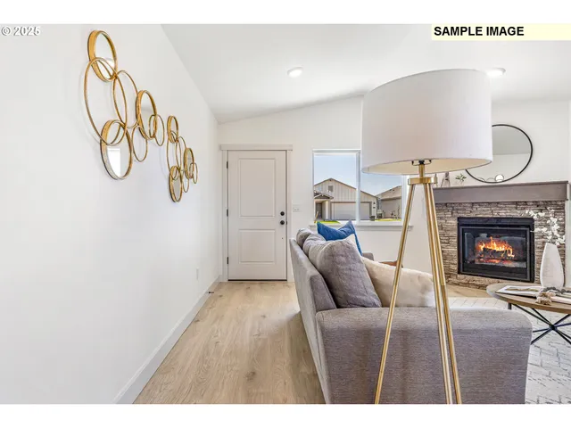 a living room with furniture a fireplace and a window
