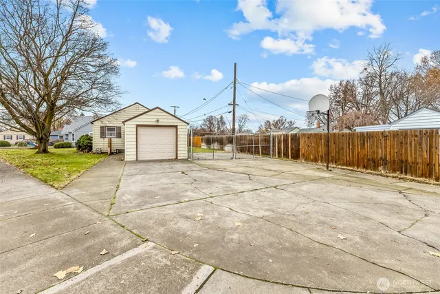 a view of a house with a backyard and trees