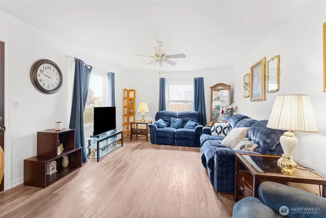 a living room with furniture a flat screen tv and a window