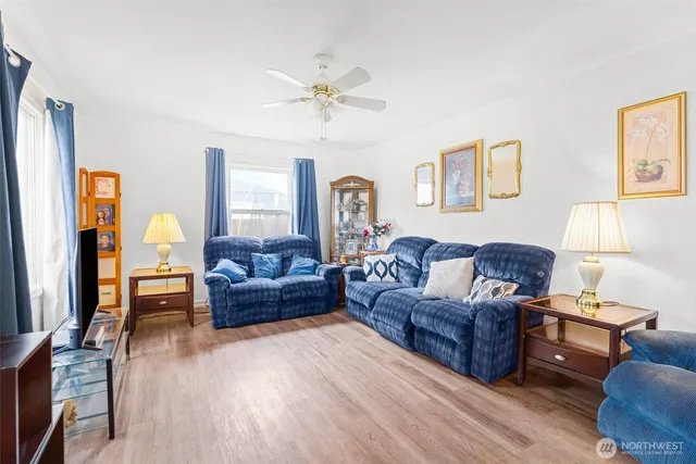 a living room with furniture and a wooden floor