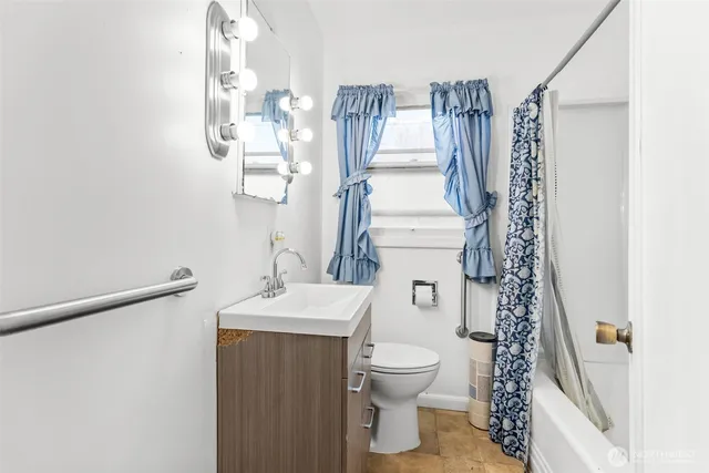 a bathroom with a toilet sink and mirror