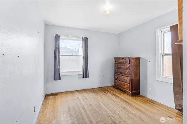 an empty room with windows and closet