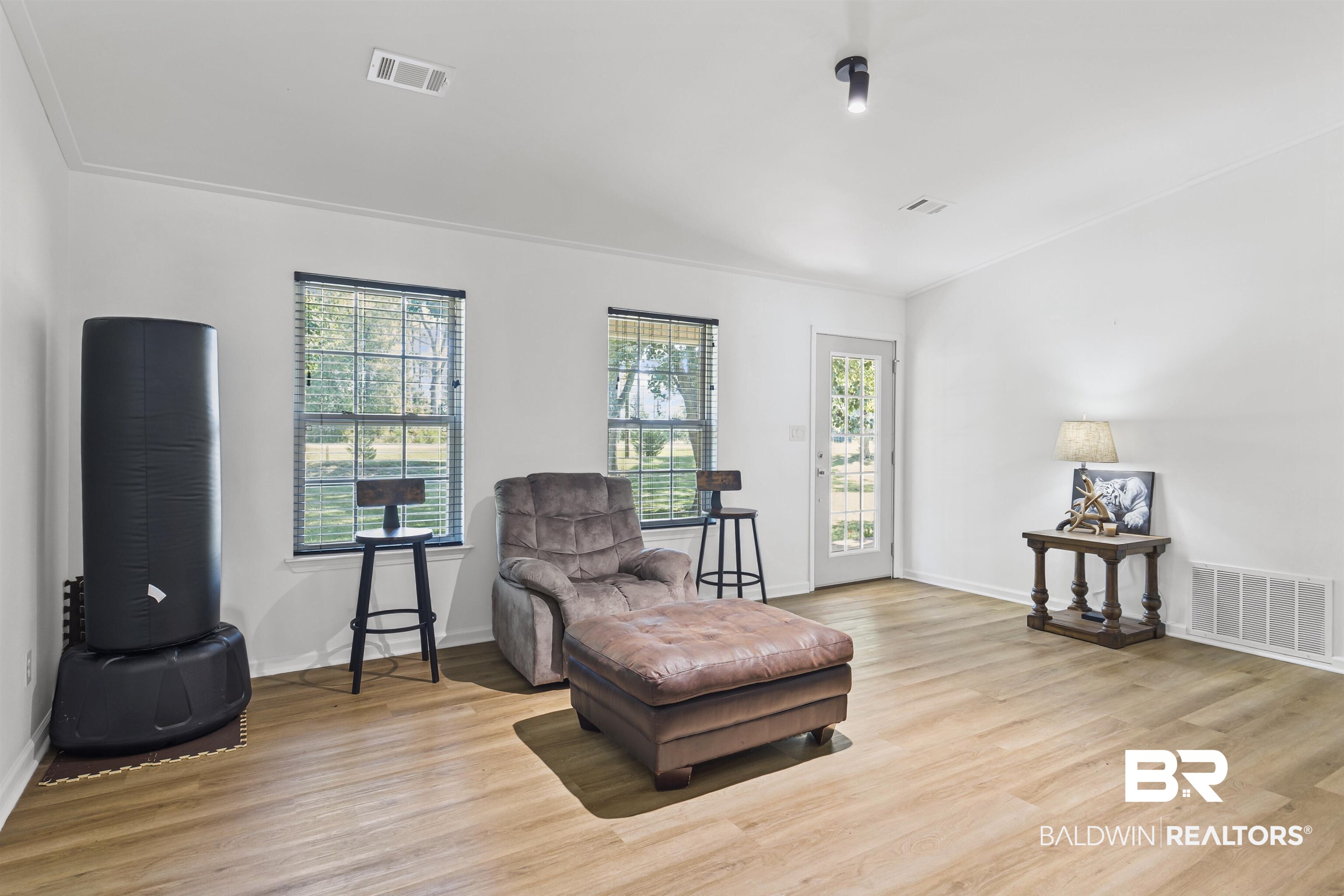 8911 Owassa Road Evergreen, AL 36401 - Photo 11 of 24 Sitting area with light wood finished floors and crown molding