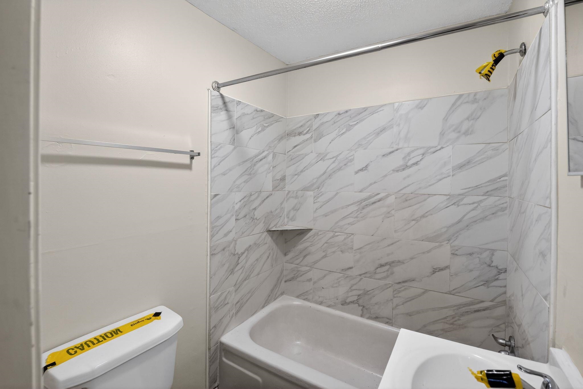 4043 Clearpool Circle Road Memphis, TN 38118 - Photo 16 of 33 a bathroom with a bathtub and a shower