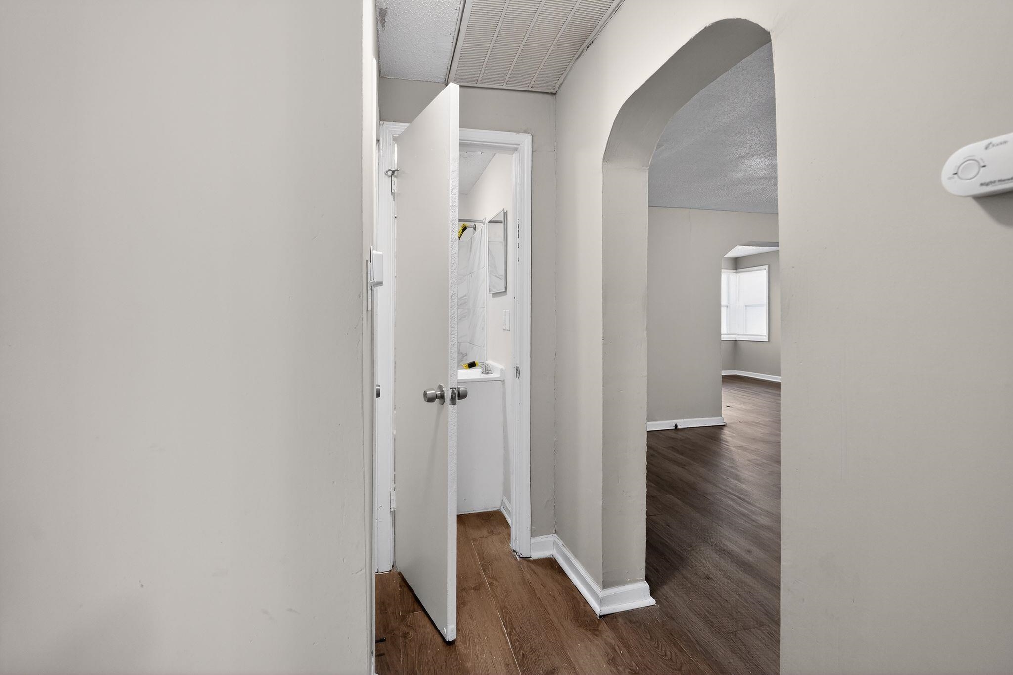 4043 Clearpool Circle Road Memphis, TN 38118 - Photo 19 of 33 Hall with arched walkways and dark wood-style floors