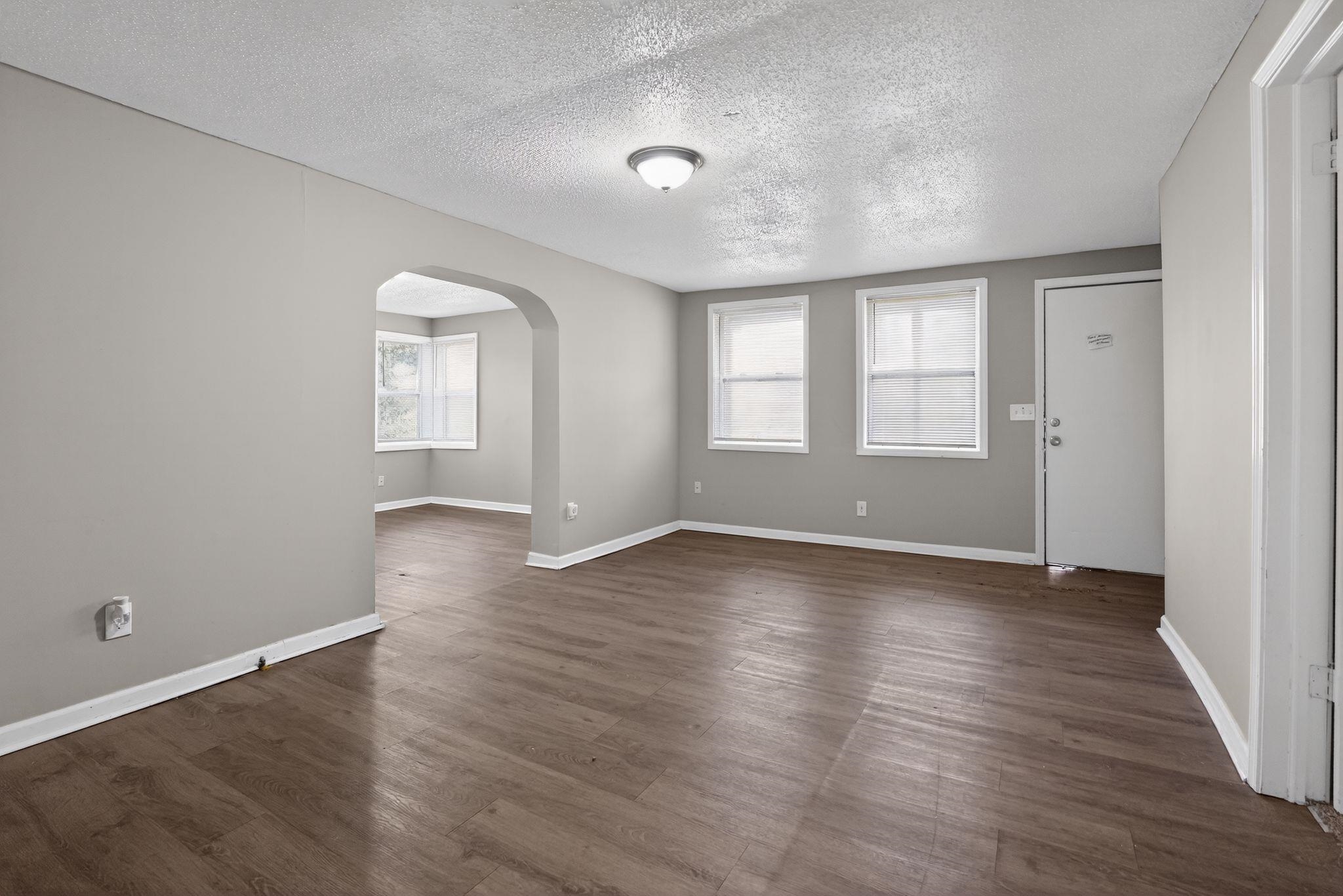4043 Clearpool Circle Road Memphis, TN 38118 - Photo 20 of 33 an empty room with wooden floor and windows