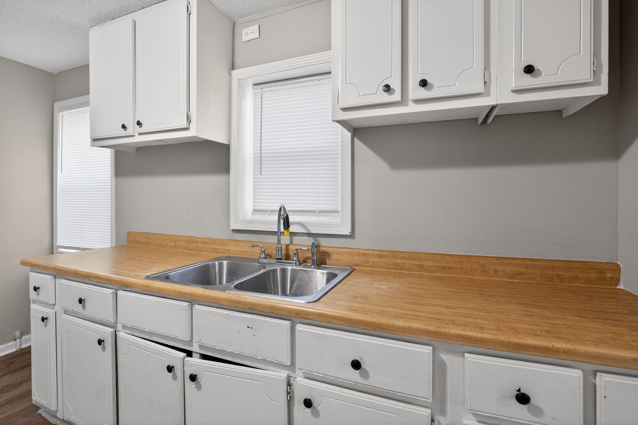 4043 Clearpool Circle Road Memphis, TN 38118 - Photo 25 of 33 a kitchen with granite countertop white cabinets and a sink