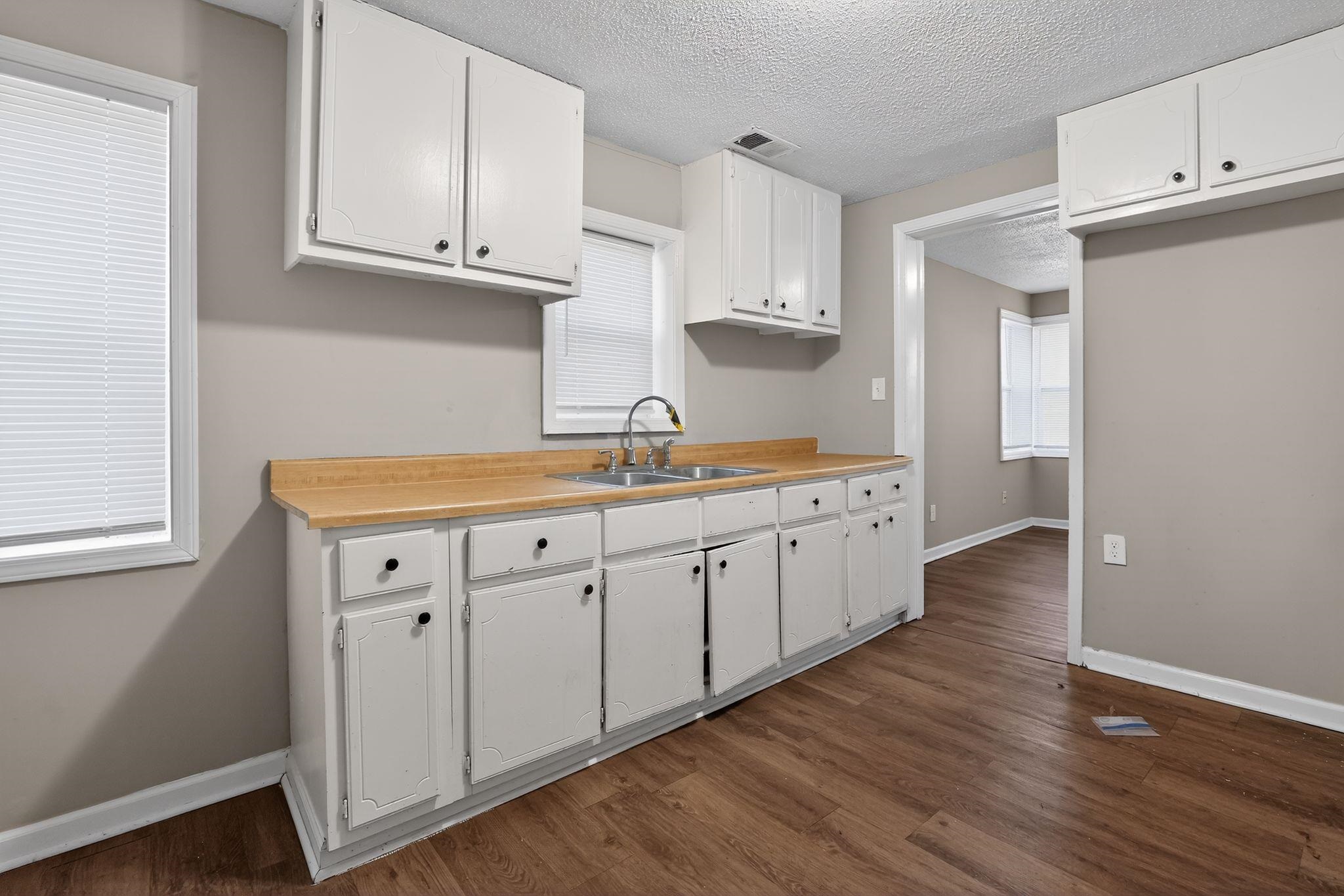 4043 Clearpool Circle Road Memphis, TN 38118 - Photo 26 of 33 a kitchen with cabinets and wooden floor