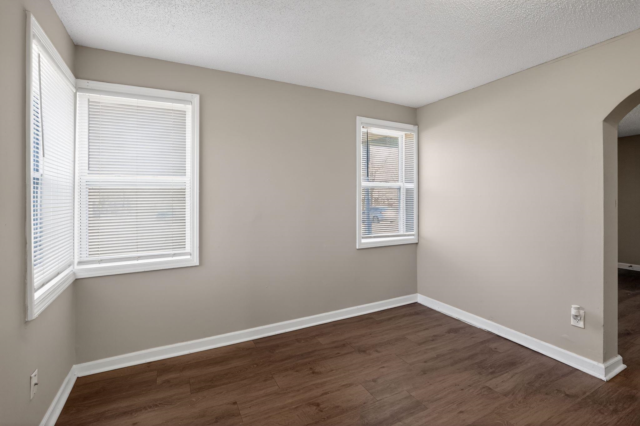 4043 Clearpool Circle Road Memphis, TN 38118 - Photo 27 of 33 a view of an empty room with wooden floor and a window