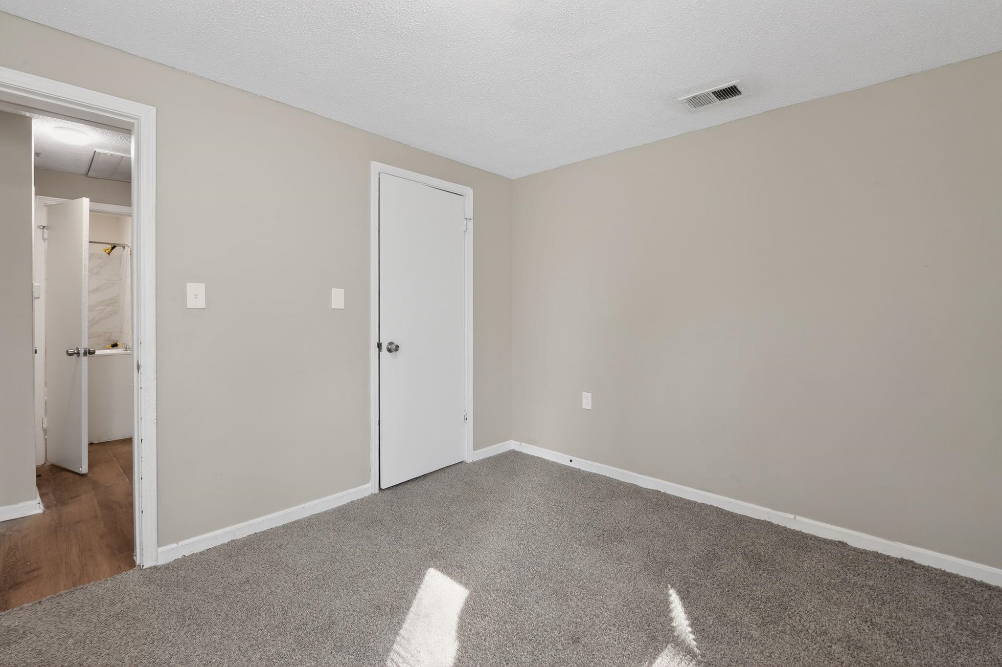 4043 Clearpool Circle Road Memphis, TN 38118 - Photo 30 of 33 Unfurnished bedroom featuring carpet and a textured ceiling