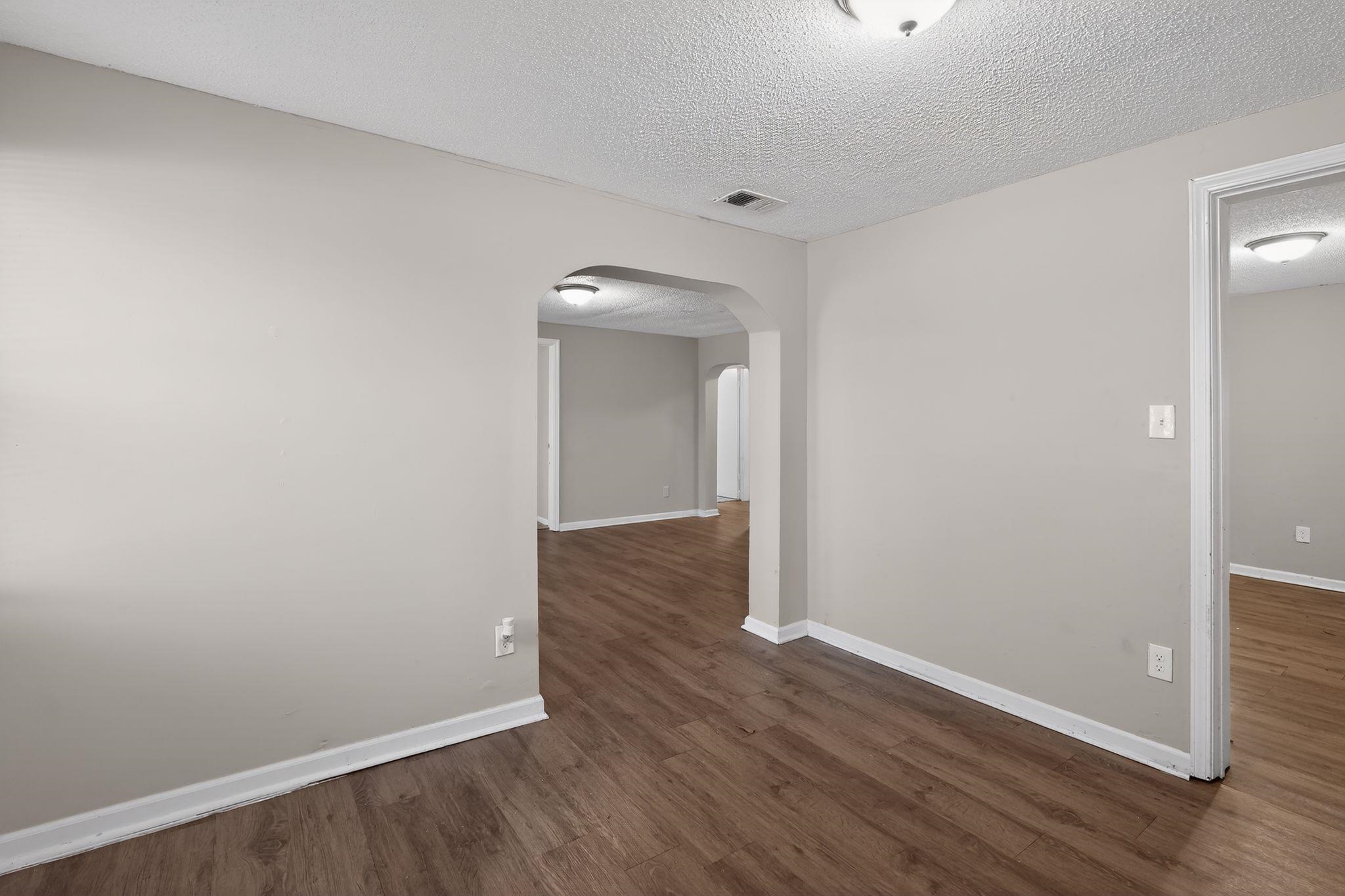 4043 Clearpool Circle Road Memphis, TN 38118 - Photo 8 of 33 a view of an empty room with wooden floor