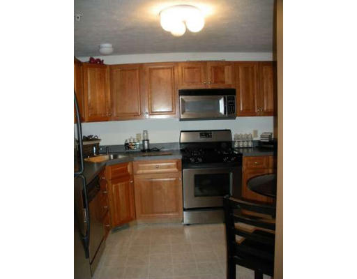 30 Caspian Way, Unit 30 Fitchburg, MA 01420 - Photo 3 of 10 a kitchen with a refrigerator and a stove top oven