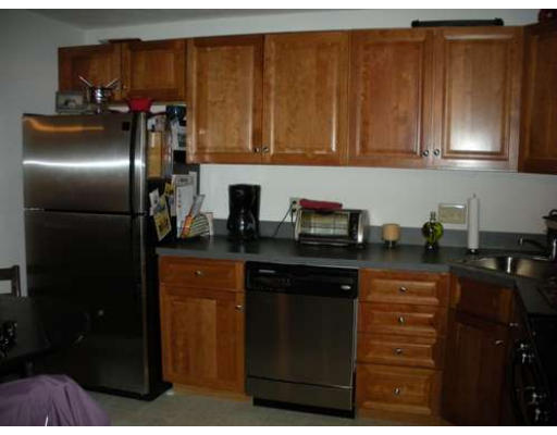 30 Caspian Way, Unit 30 Fitchburg, MA 01420 - Photo 5 of 10 a kitchen with stainless steel appliances granite countertop a refrigerator and cabinets