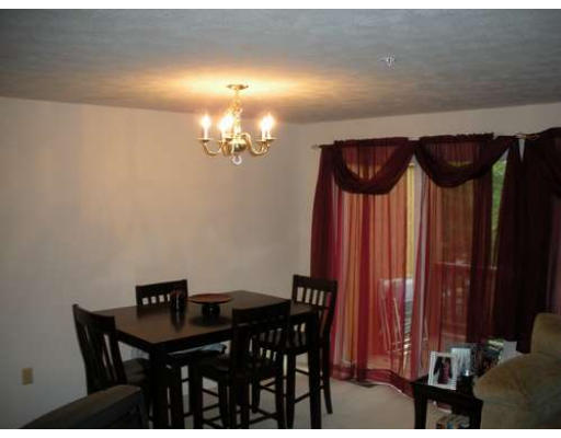 30 Caspian Way, Unit 30 Fitchburg, MA 01420 - Photo 6 of 10 a view of a dining room with furniture and chandelier