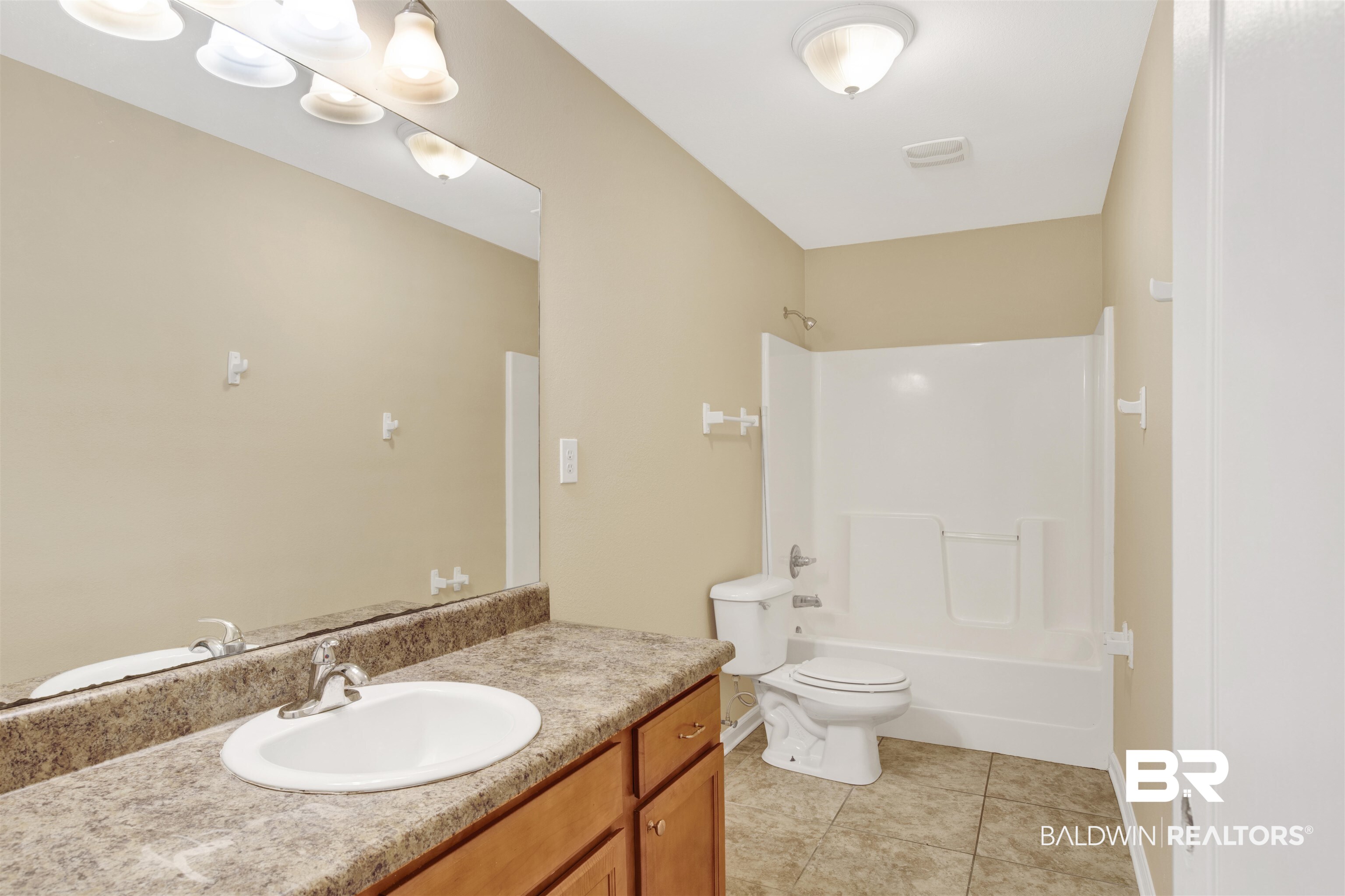2002 Shelene Way Foley, AL 36535 - Photo 18 of 23 Full bath featuring vanity, light tile patterned floors, and bathtub / shower combination