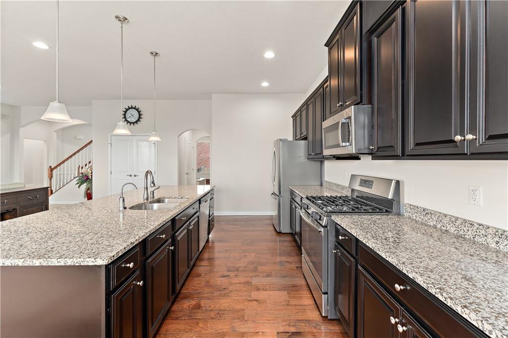 817 Oneida Circle Mars, PA 16046 - Photo 18 of 50 a kitchen with granite countertop a sink a counter top space stove and cabinets