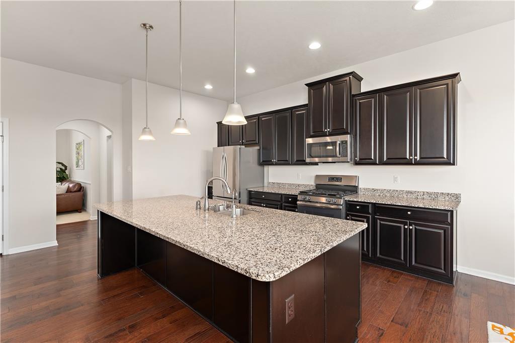 817 Oneida Circle Mars, PA 16046 - Photo 19 of 50 a kitchen with stainless steel appliances granite countertop a sink wooden cabinets and granite counter tops