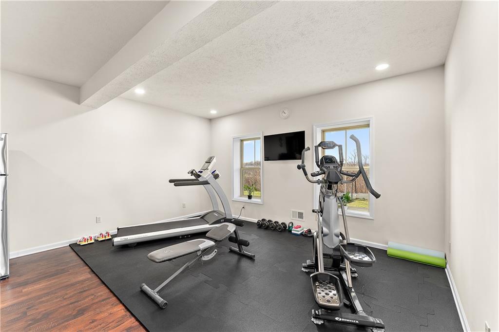 817 Oneida Circle Mars, PA 16046 - Photo 45 of 50 a room with gym equipment and windows