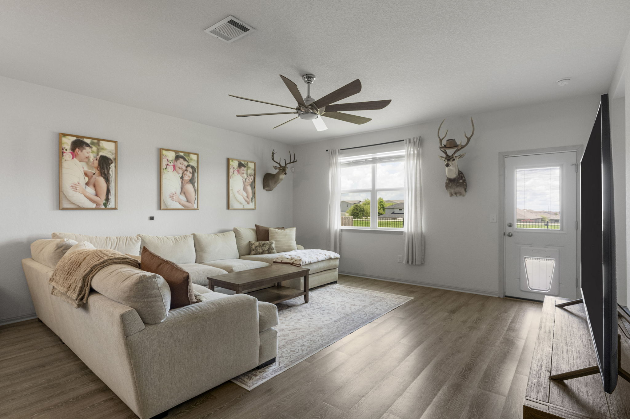 185 Struss Drive Georgetown, TX 78626 - Photo 8 of 23 Natural light fills this gathering space, featuring durable wood flooring and an outdoor access door.