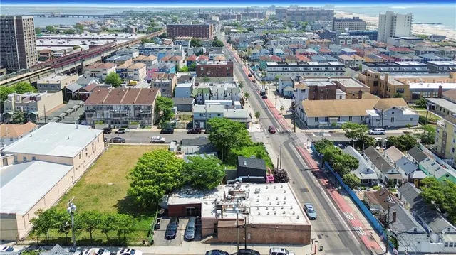 an aerial view of residential houses with city view