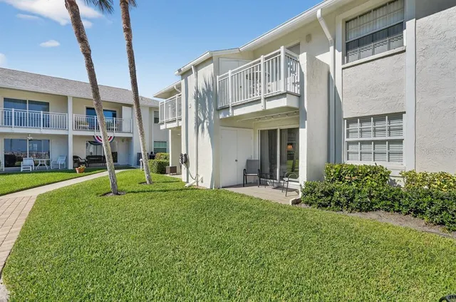 a view of an house with backyard porch and sitting area