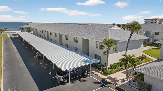 a roof deck with table and chairs