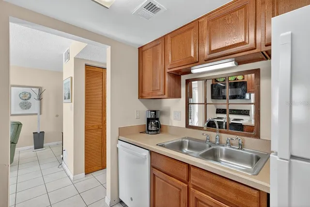 a kitchen with stainless steel appliances granite countertop a sink and cabinets