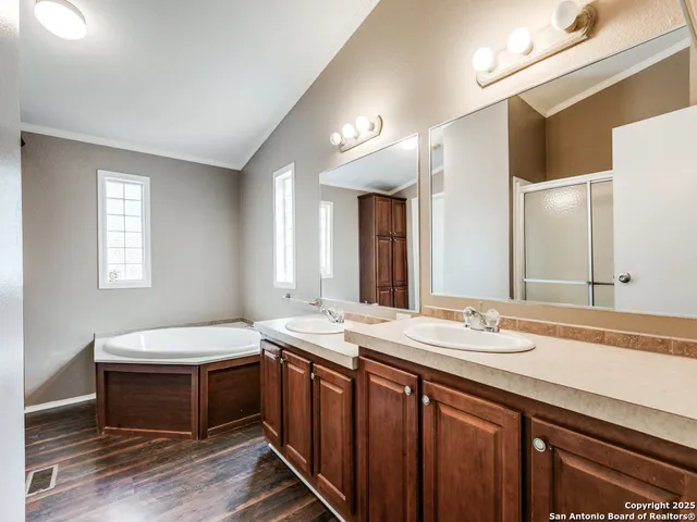 a spacious bathroom with a granite countertop sink and a mirror