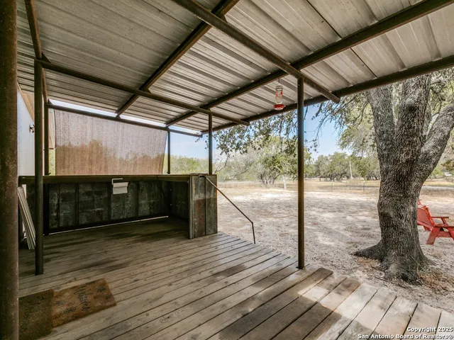 a view of a porch with wooden floor