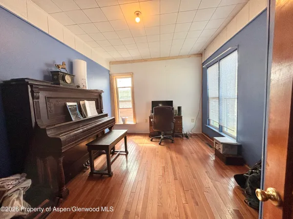 a view of a livingroom with wooden floor and closet